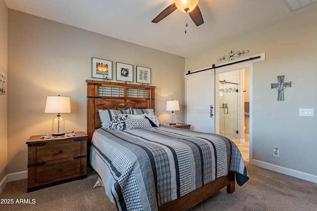 carpeted bedroom featuring connected bathroom, ceiling fan, and a barn door