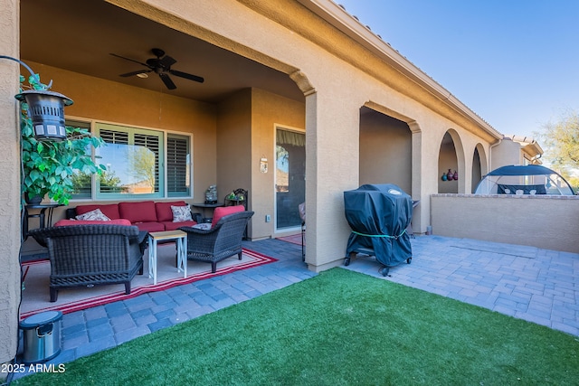 view of patio with grilling area, an outdoor living space, and ceiling fan