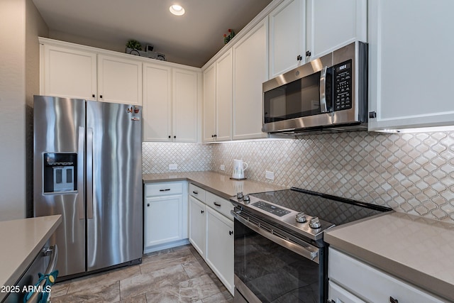 kitchen featuring white cabinets, decorative backsplash, and appliances with stainless steel finishes