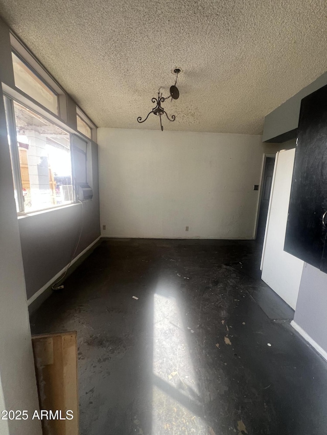 unfurnished room with a textured ceiling