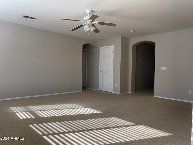 empty room with carpet flooring and ceiling fan