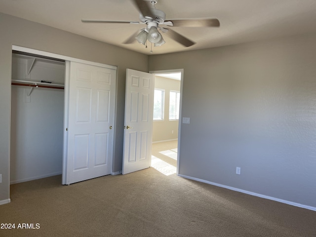 unfurnished bedroom with carpet, ceiling fan, and a closet