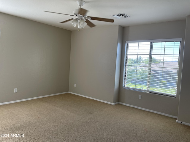 spare room with light colored carpet and ceiling fan