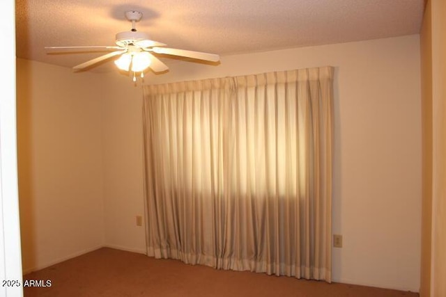 unfurnished room with a textured ceiling, ceiling fan, and carpet flooring