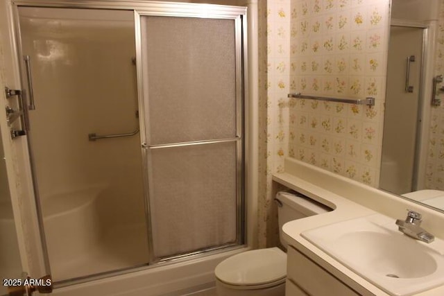 bathroom with toilet, vanity, and walk in shower