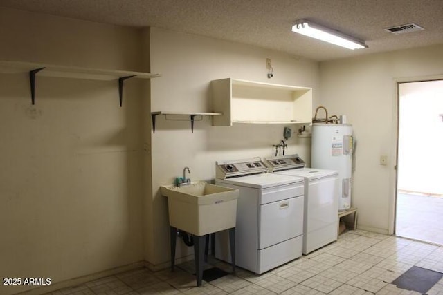 laundry area with independent washer and dryer, sink, electric water heater, and a textured ceiling