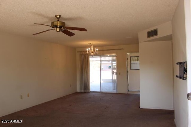 carpeted empty room featuring ceiling fan with notable chandelier and a textured ceiling