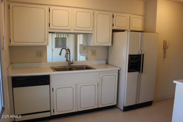 kitchen with white cabinetry, sink, and white appliances