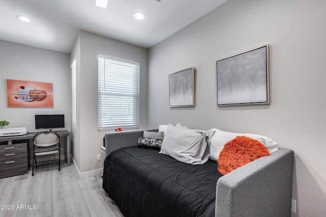 bedroom featuring baseboards, wood finished floors, and recessed lighting
