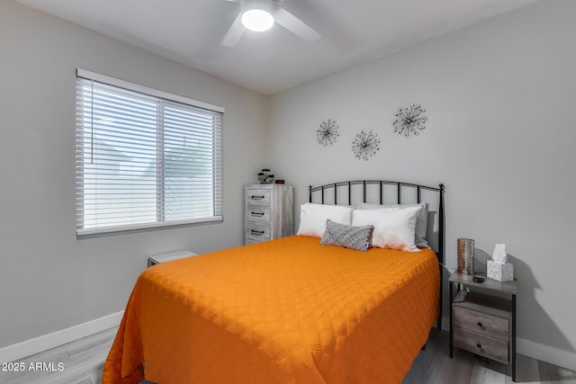 bedroom with wood finished floors, baseboards, and ceiling fan