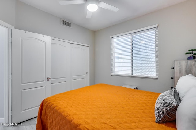 bedroom featuring visible vents, a closet, and ceiling fan