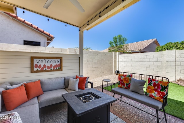 view of patio / terrace featuring fence, a ceiling fan, and an outdoor living space with a fire pit