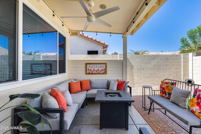 view of patio with fence, a ceiling fan, and an outdoor living space with a fire pit