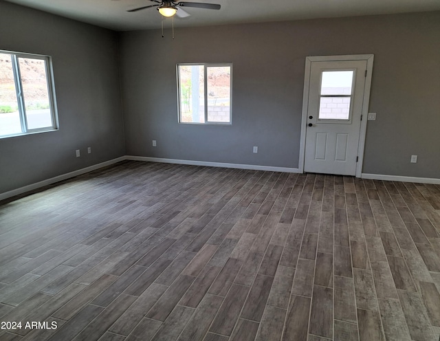 empty room with ceiling fan and hardwood / wood-style flooring