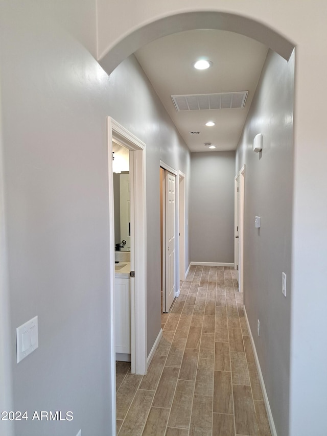 corridor with hardwood / wood-style floors