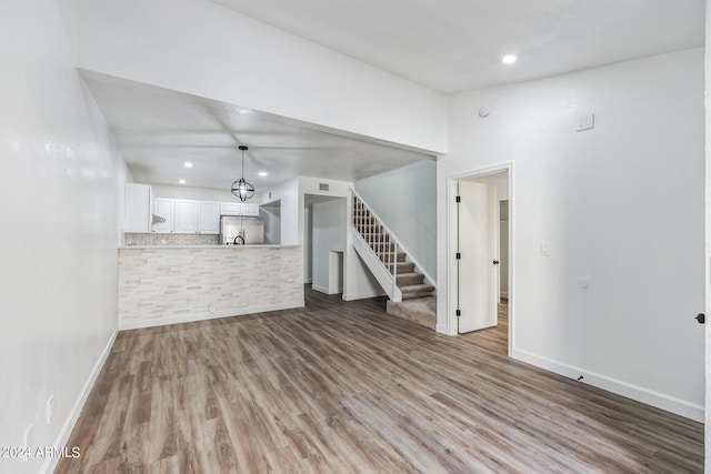 unfurnished living room with light hardwood / wood-style flooring