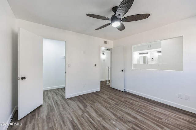 unfurnished bedroom featuring ceiling fan, a closet, and hardwood / wood-style flooring