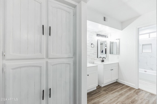 bathroom featuring vanity and hardwood / wood-style floors