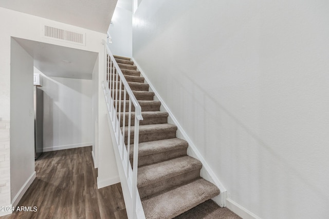 stairs with wood-type flooring