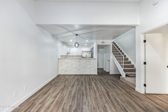 unfurnished living room featuring wood-type flooring