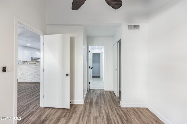 corridor with light hardwood / wood-style flooring