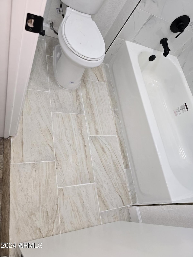 bathroom featuring a bathtub and toilet