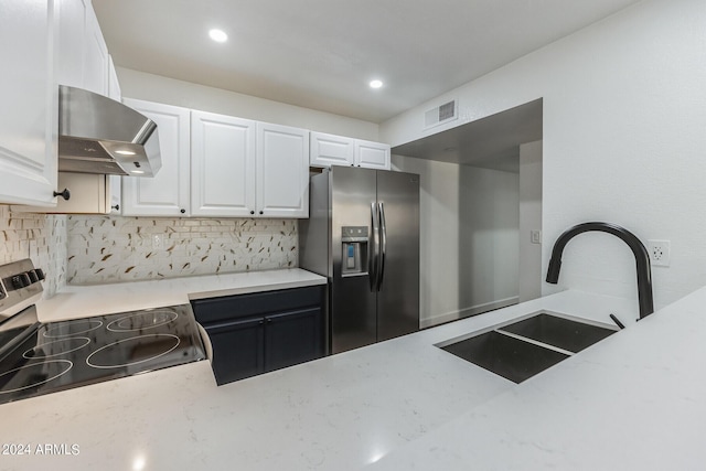 kitchen with appliances with stainless steel finishes, decorative backsplash, sink, white cabinetry, and range hood