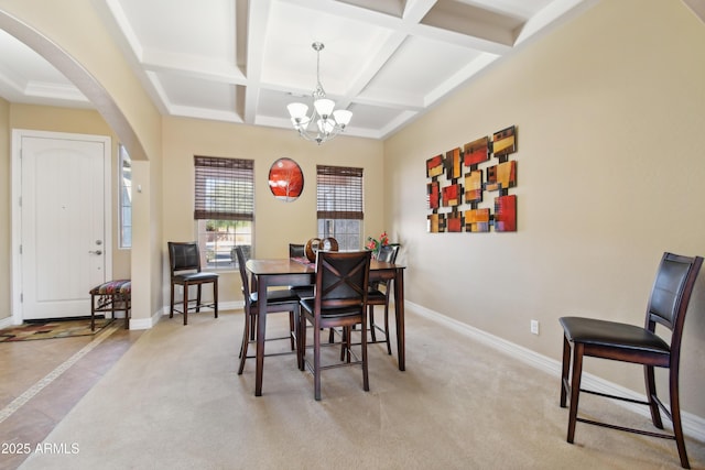 carpeted dining space featuring coffered ceiling, beam ceiling, and a notable chandelier