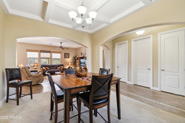 tiled dining space featuring coffered ceiling, ceiling fan with notable chandelier, and beamed ceiling