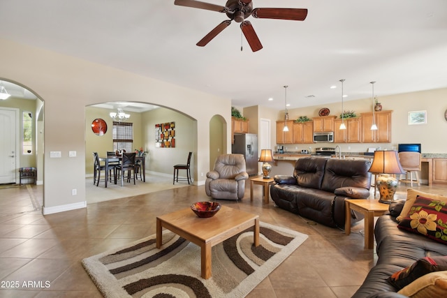 living room with sink, ceiling fan, and light tile patterned floors