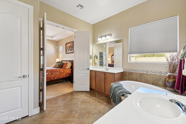 bathroom featuring vanity, a bathtub, and tile patterned floors