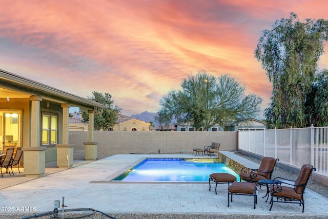 pool at dusk with a patio