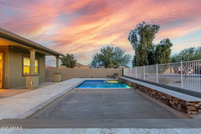 pool at dusk with a patio