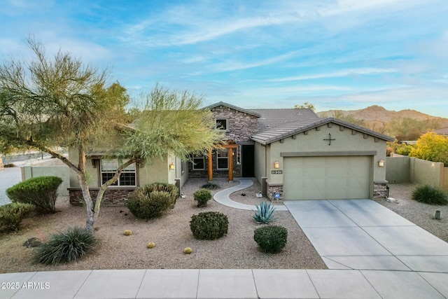 view of front of home featuring a mountain view and a garage