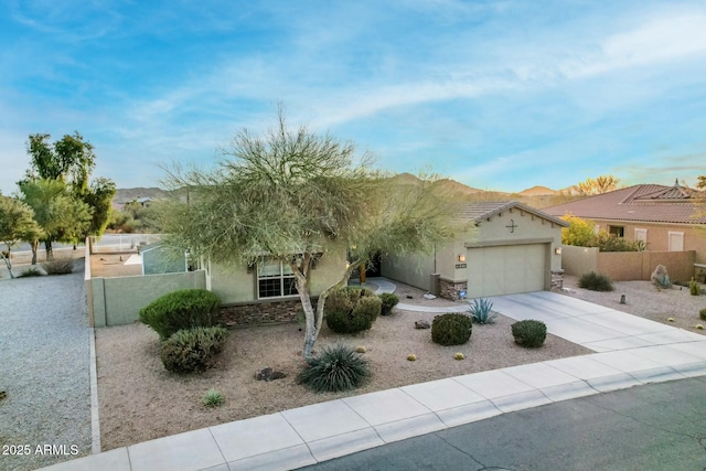 view of front facade featuring a garage and a mountain view