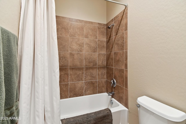 bathroom featuring toilet and shower / bath combo