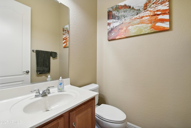 bathroom featuring toilet and vanity