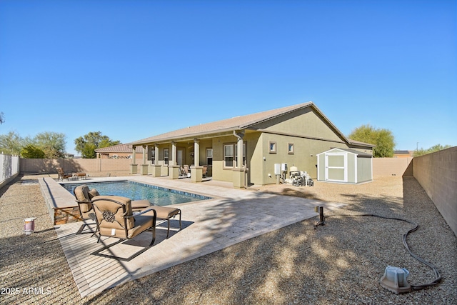 exterior space featuring a fenced in pool, a patio, and a storage unit