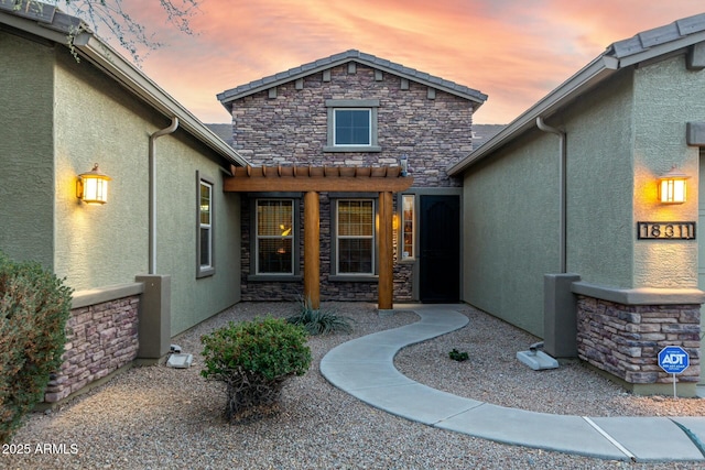 view of exterior entry at dusk