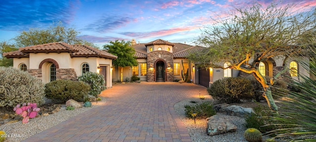 mediterranean / spanish-style home with a garage