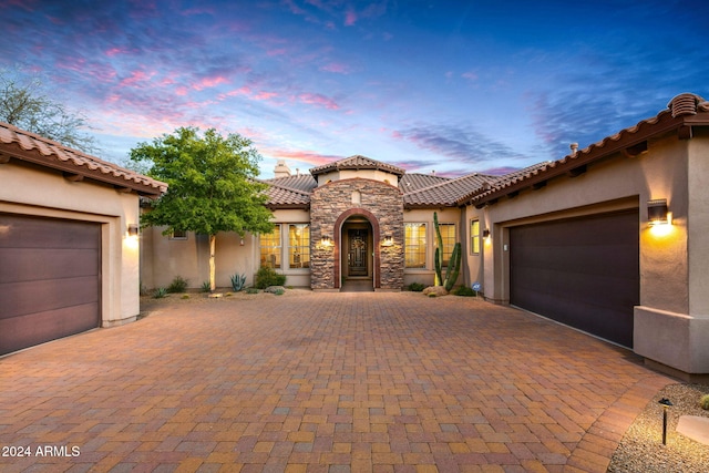 mediterranean / spanish-style house with a garage