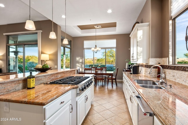 kitchen with white cabinets, a healthy amount of sunlight, and sink