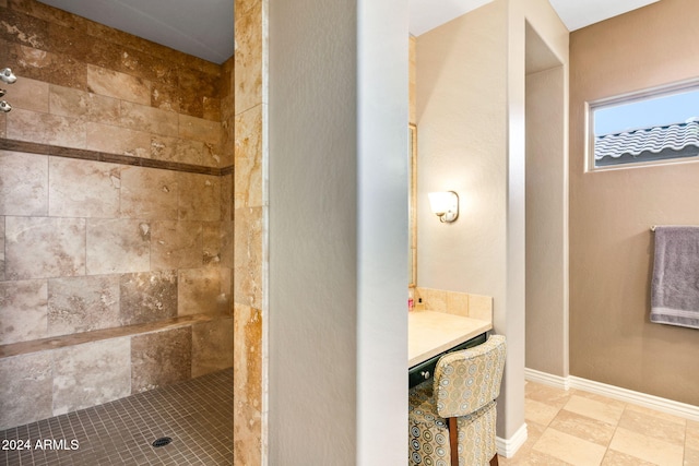 bathroom featuring vanity and tiled shower