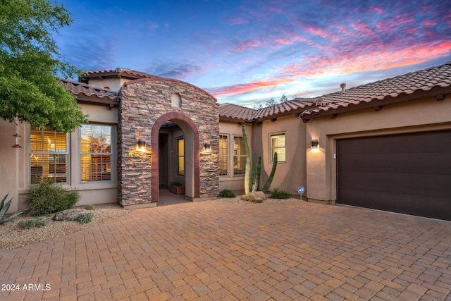 mediterranean / spanish-style home featuring a garage