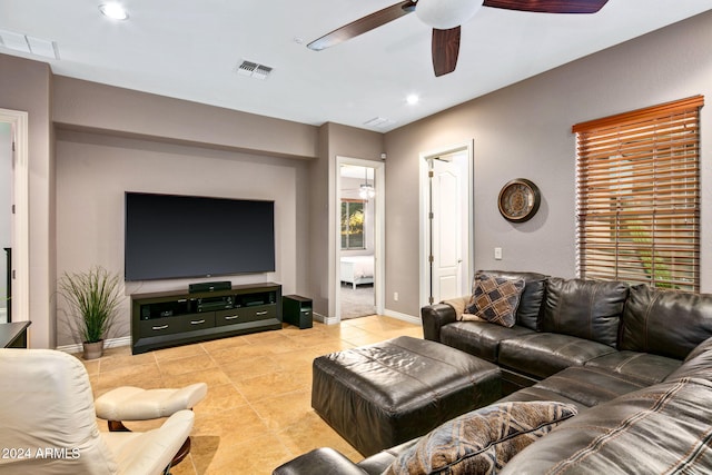 tiled living room with ceiling fan