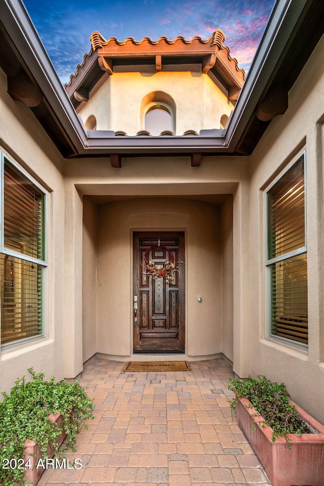 view of exterior entry at dusk