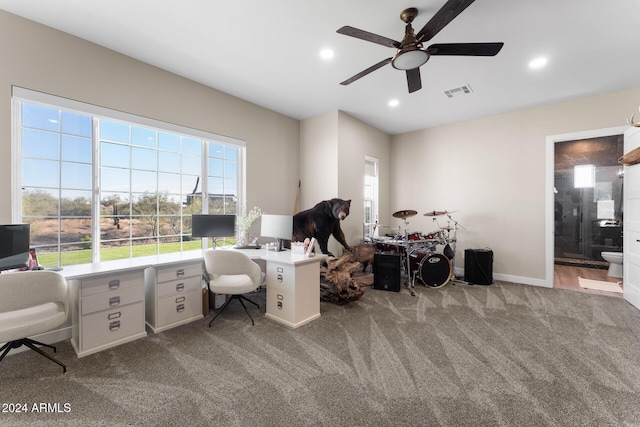 carpeted home office featuring ceiling fan