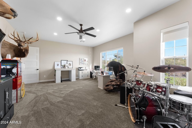 interior space featuring ceiling fan and carpet