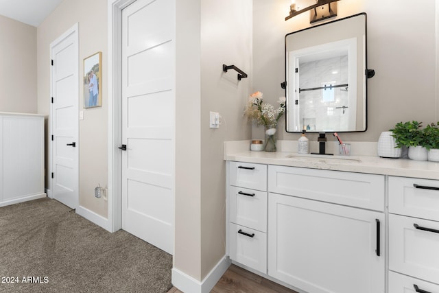 bathroom with walk in shower and vanity