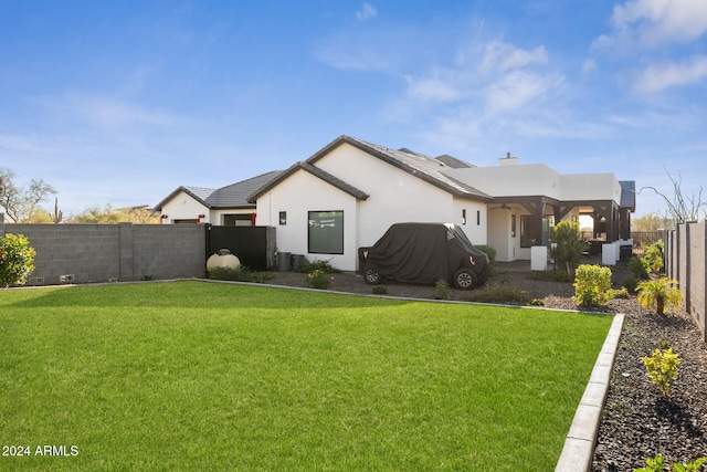 back of house featuring a yard